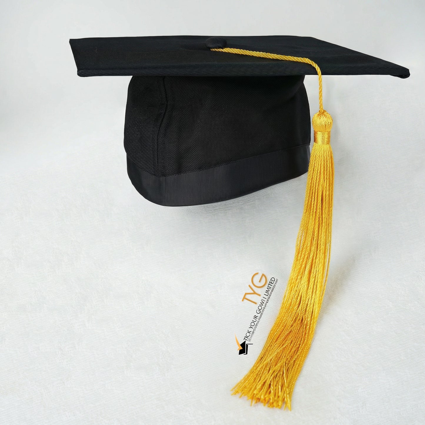 Black graduation cap with yellow tassel on a white background