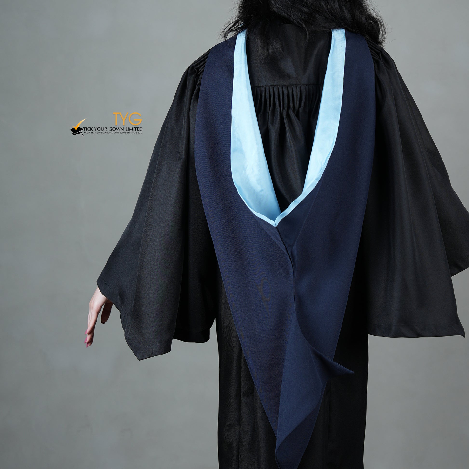black dress with blue graduation gown African American Student Girl in Black Graduation Gown with Diploma, at Blue Suit Posed Stock Photo