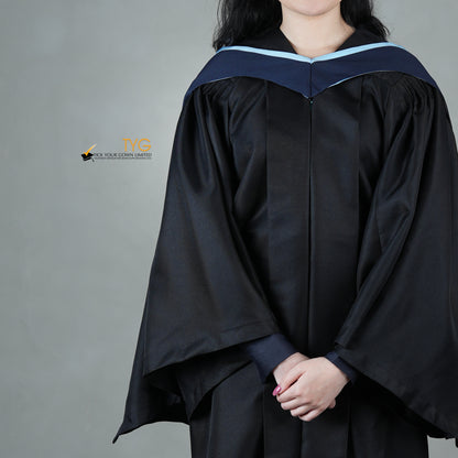 A detailed front view of a graduate in a black gown with a navy blue hood with light blue lining against a gray background