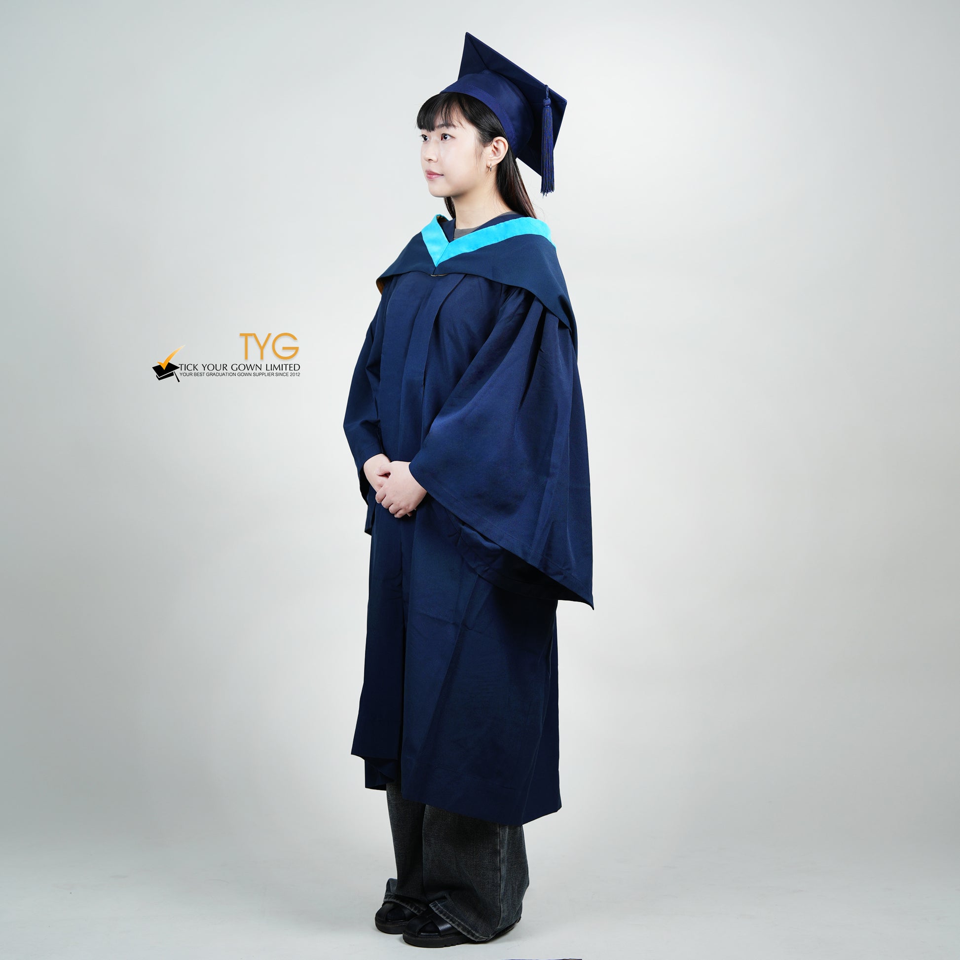A profile view of a person wearing a blue graduation gown and cap on a white background