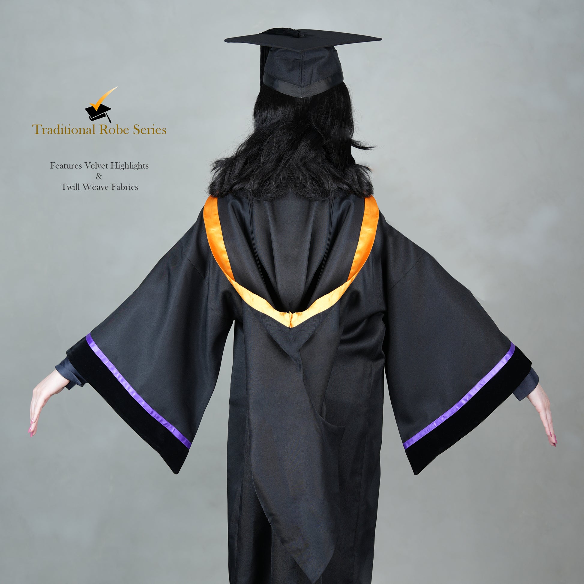 A person wearing a black bachelor graduation gown from the back with a snap-on hood design, velvet highlights, and a mortarboard set.