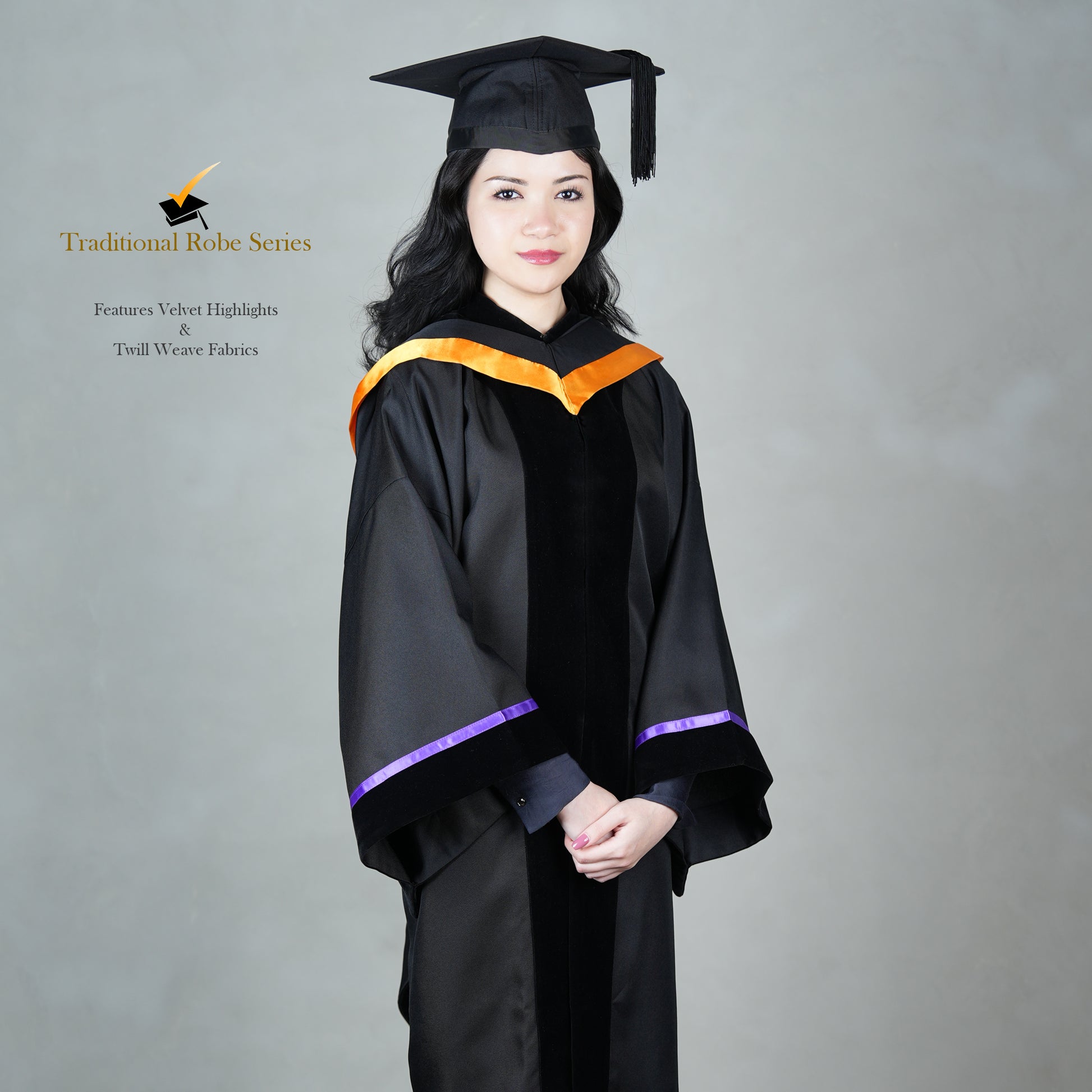 A person wearing a black bachelor graduation gown with velvet highlights, snap-on hood design, and a mortarboard set, posed elegantly.