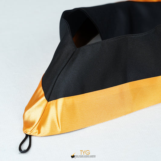 Detailed view of a bachelor’s graduation hood in black with gold satin lining.