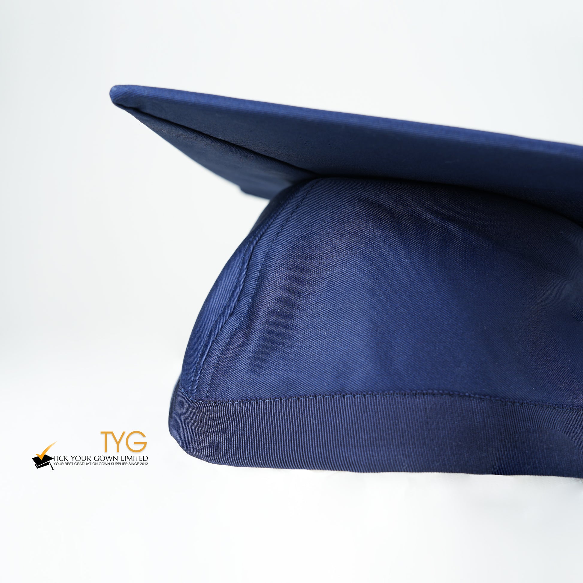 A detailed view of a blue graduation cap with a blue tassel on a white background.