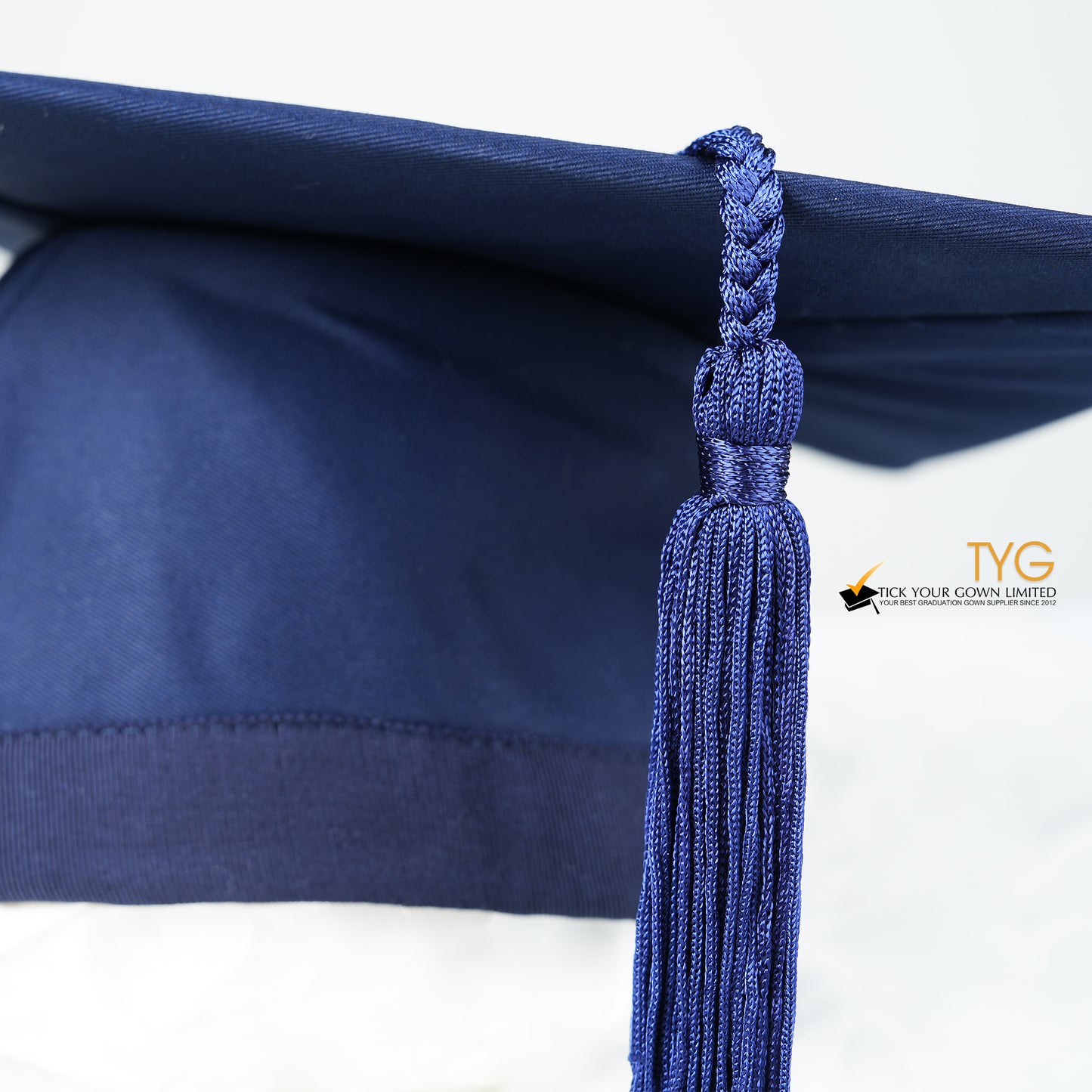 A detailed view of a blue tassel on a white background.