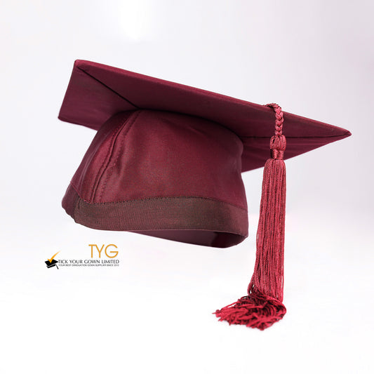 Red graduation cap with a red tassel on a white background.