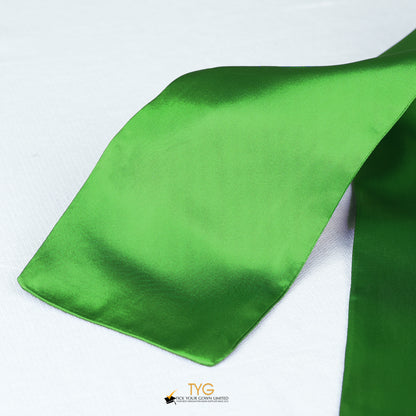 Detailed view of a green graduation sash fabric on a white background.