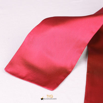 Detailed view of a red graduation sash fabric on a white background.