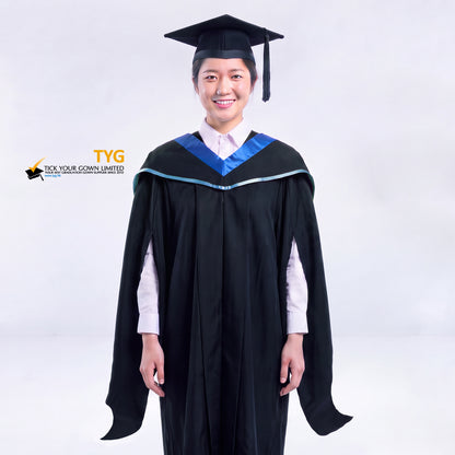A woman in a black master's graduation gown classic UK with a blue hood with sky blue accent and with a black mortarboard cap with an black tassel against a gray background.