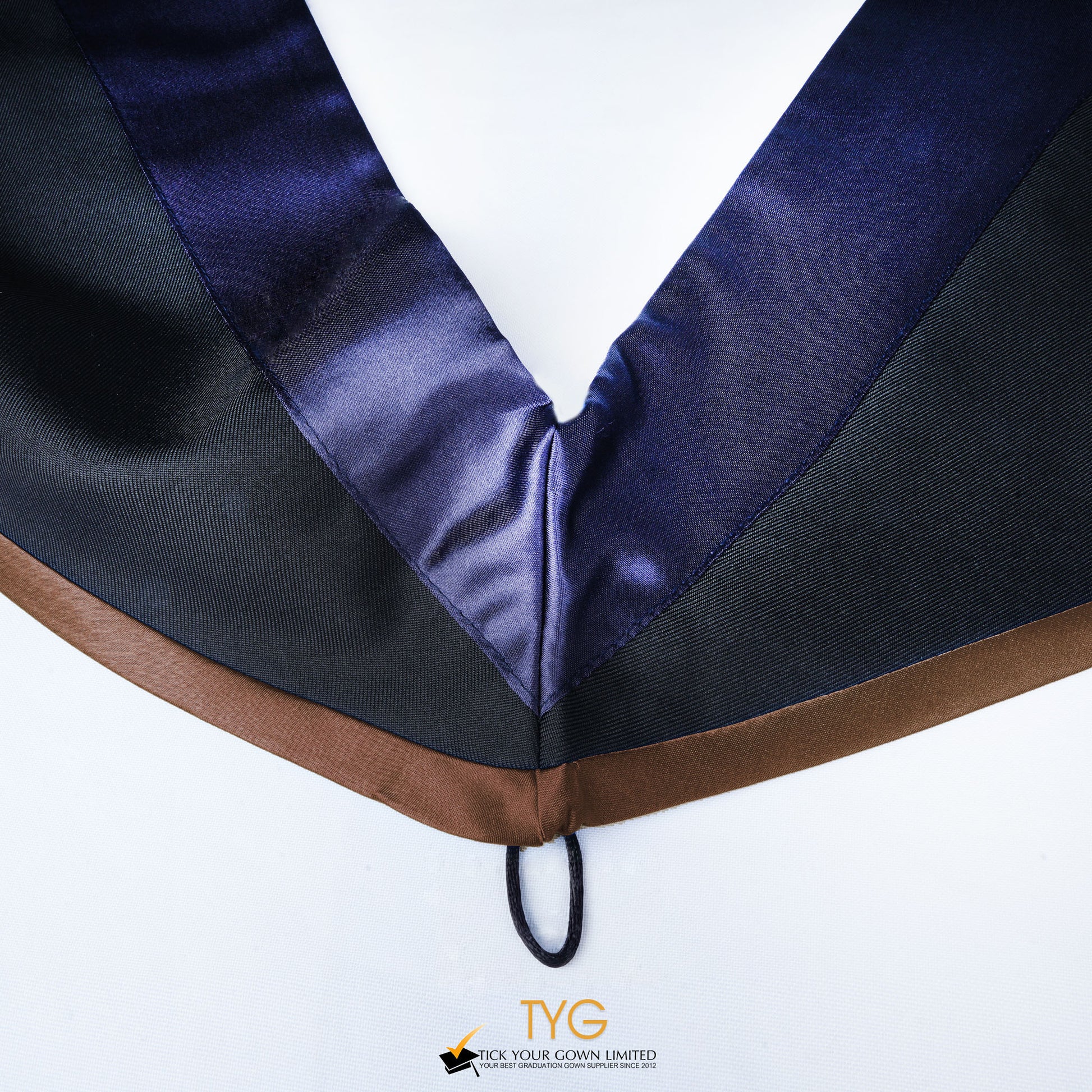 Close-up of a master's graduation hood with black body, dark navy blue satin hood and brown lining.