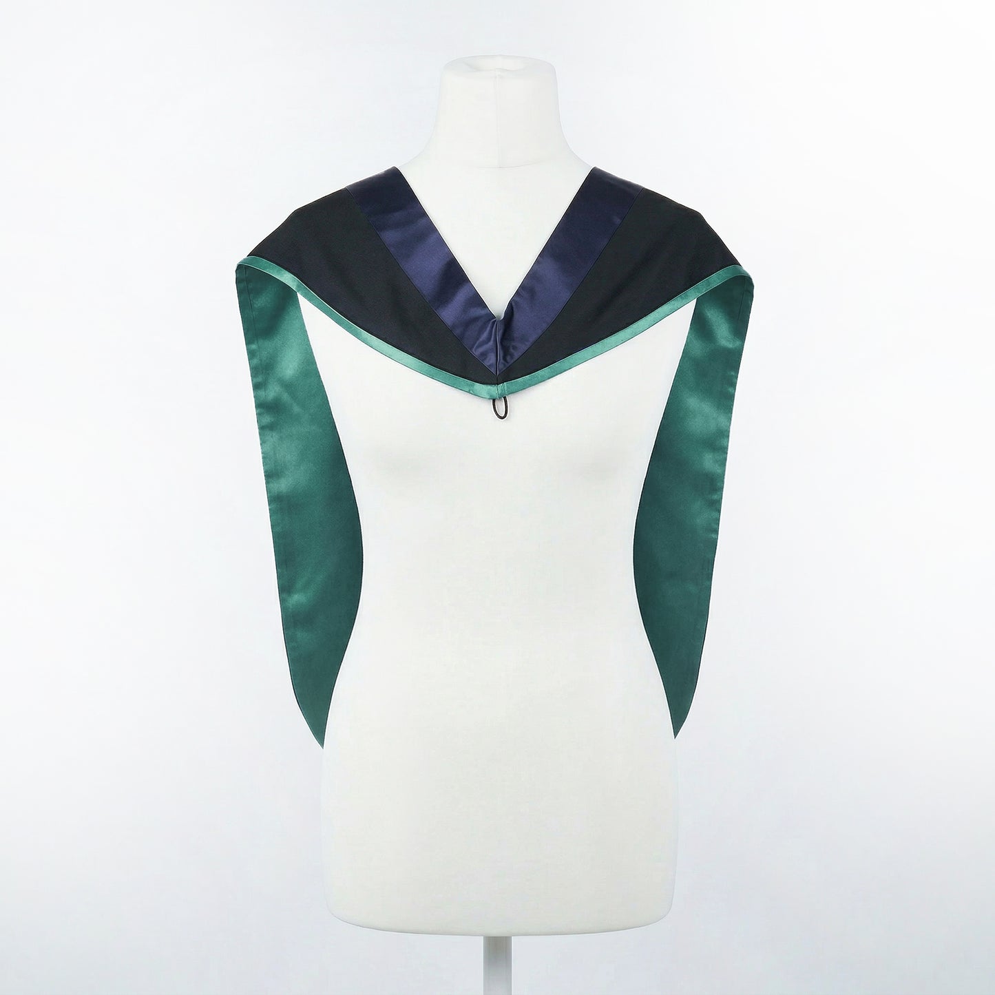 Master's graduation hood displayed on a mannequin showing full shape with black body, dark navy blue hood, and emerald satin lining.