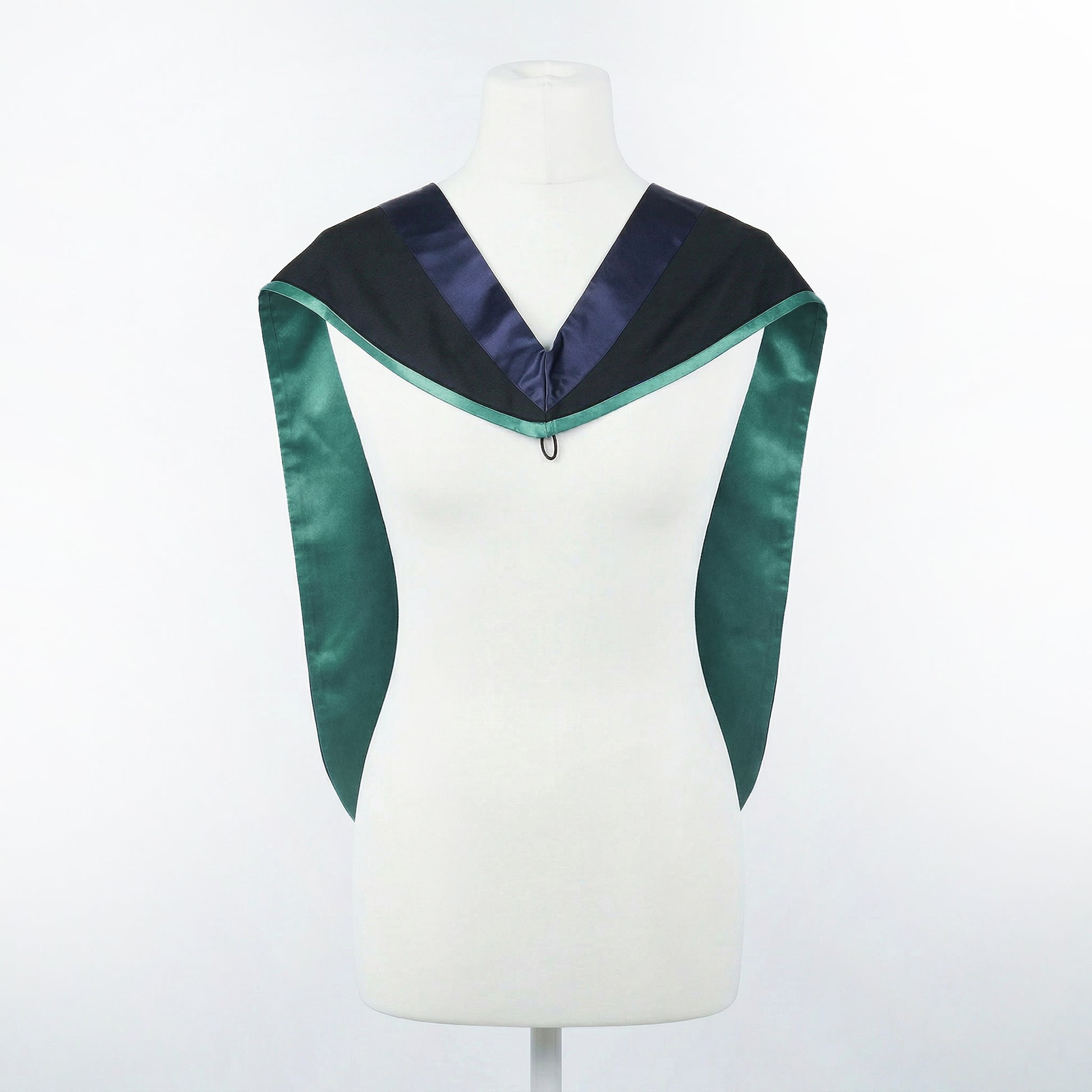 Master's graduation hood displayed on a mannequin showing full shape with black body, dark navy blue hood, and emerald satin lining.