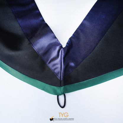 Close-up of a master's graduation hood with black body, dark navy blue satin hood and emerald lining.