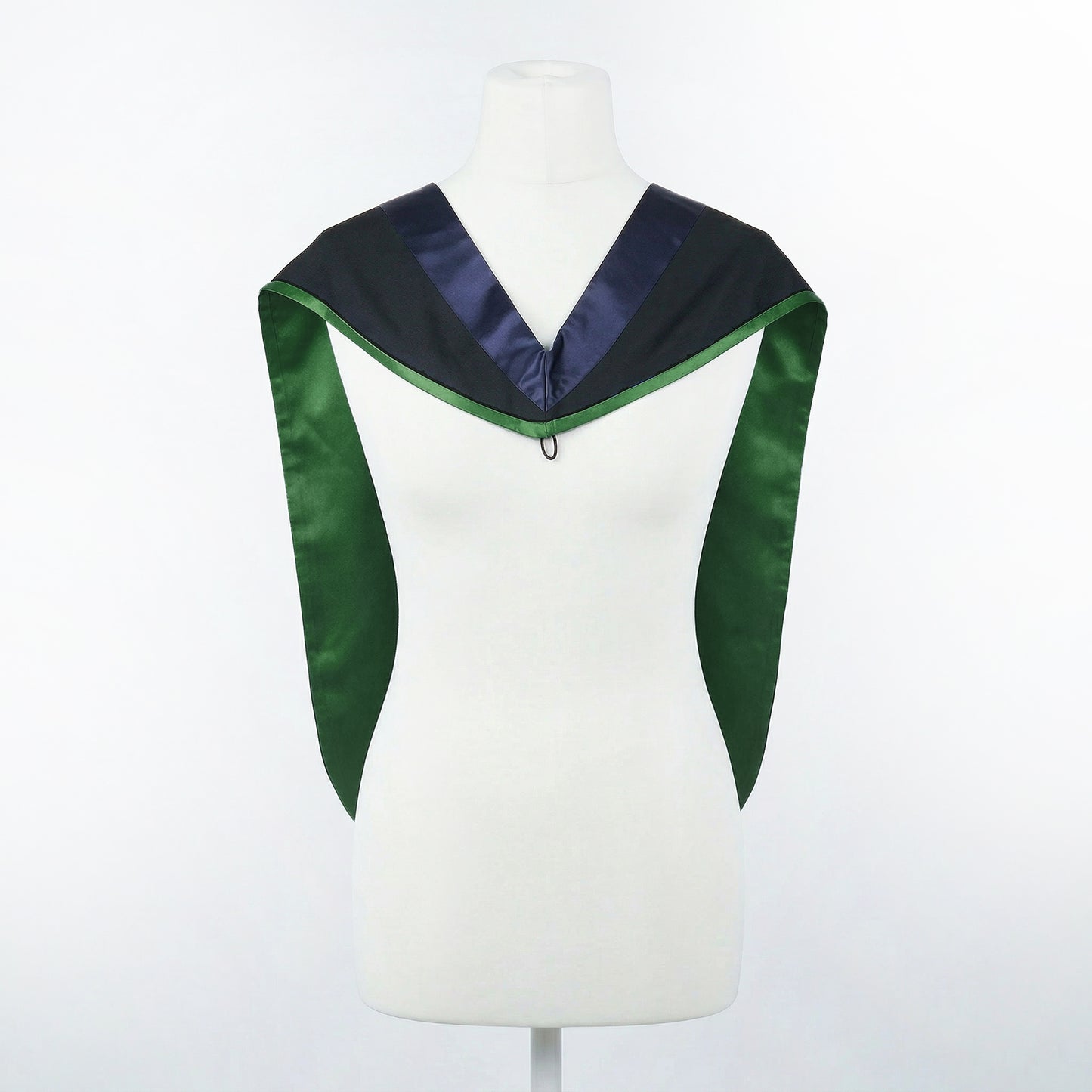 Master's graduation hood displayed on a mannequin showing full shape with black body, dark navy blue hood, and green satin lining.