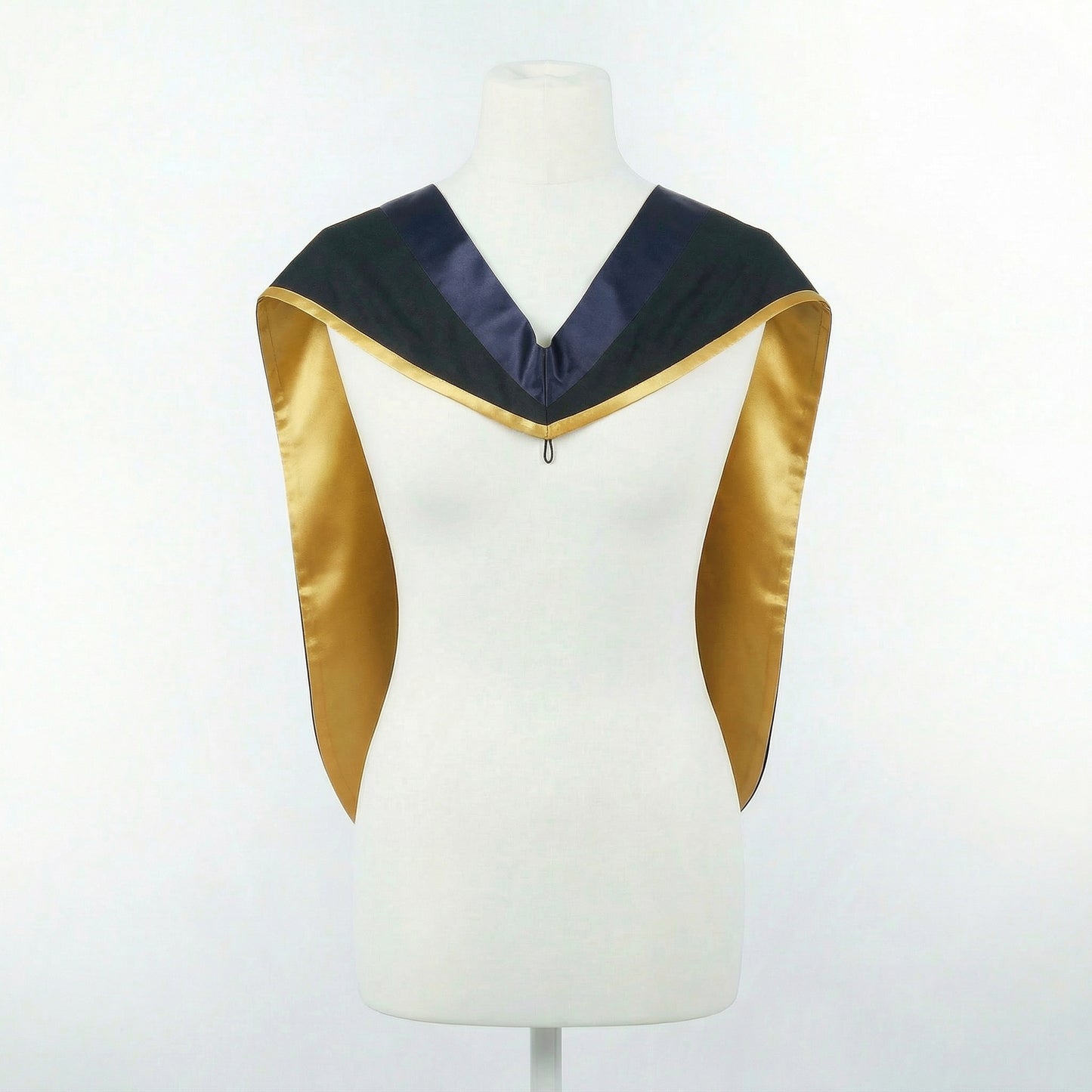 Master's graduation hood displayed on a mannequin showing full shape with black body, dark navy blue hood, and gold satin lining.