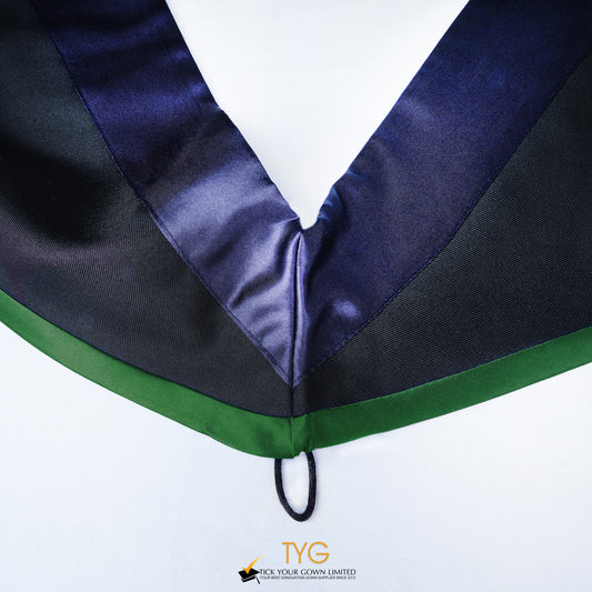 Close-up of a master's graduation hood with black body, dark navy blue satin hood and green lining.