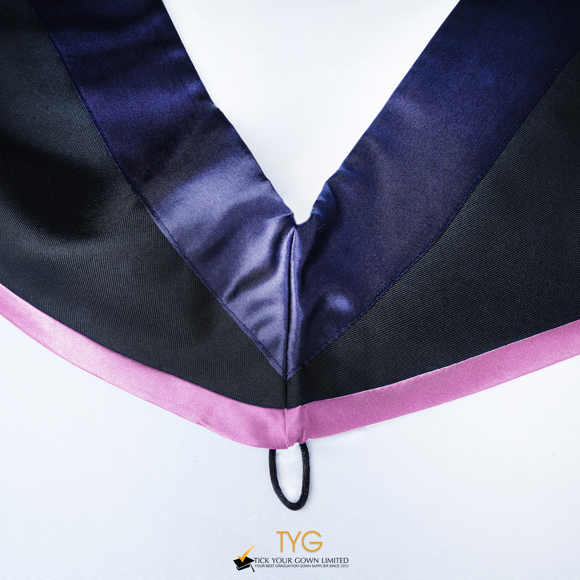 Close-up of a master's graduation hood with black body, dark navy blue satin hood and lilac lining.