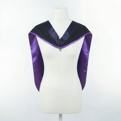 Master's graduation hood displayed on a mannequin showing full shape with black body, dark navy blue hood, and purple satin lining.