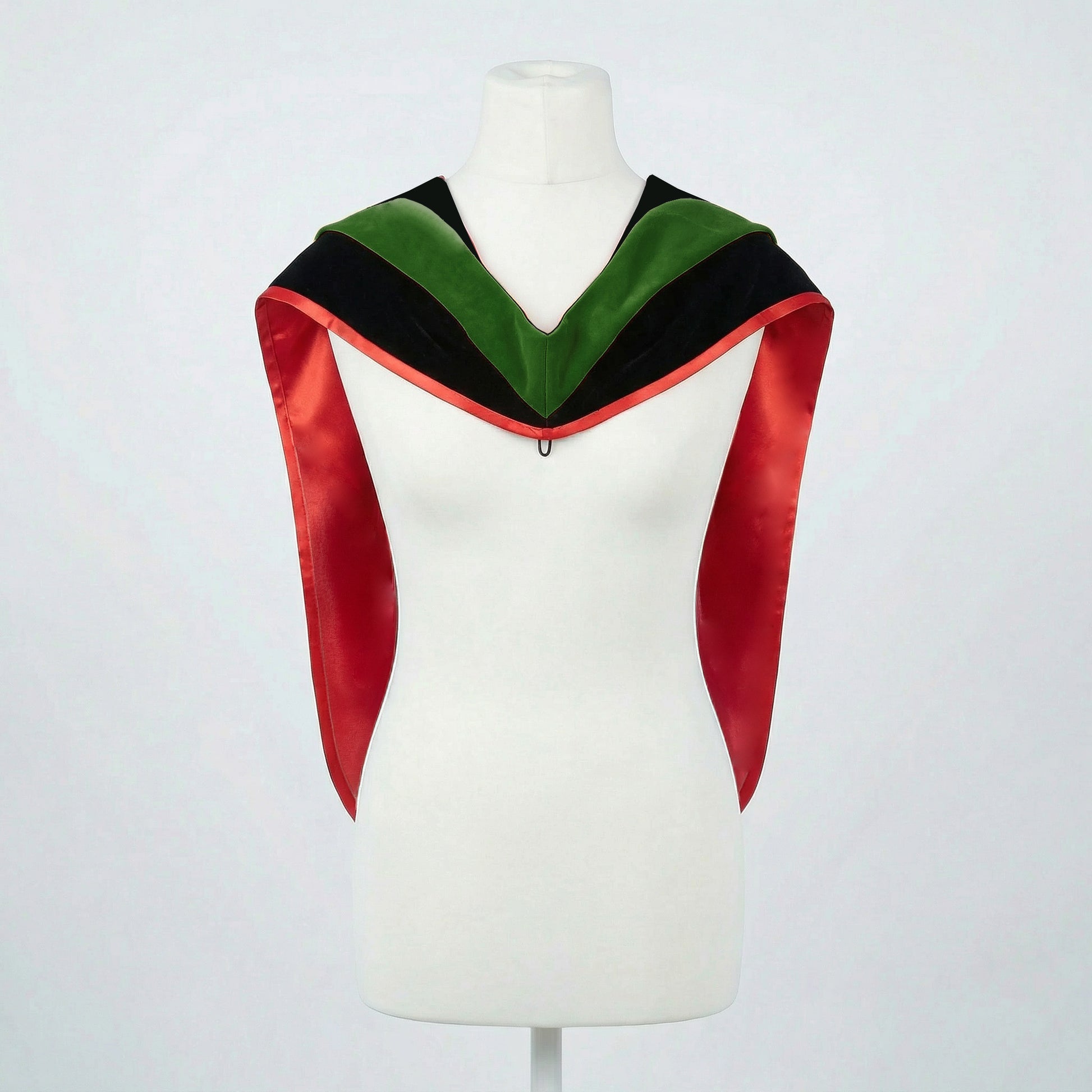 Master's graduation hood displayed on a mannequin showing full shape with black velvet body, forest green velvet hood and red satin lining.