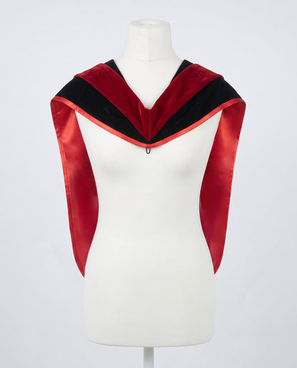 Master's graduation hood displayed on a mannequin showing full shape with black velvet body, red velvet hood and red satin lining.