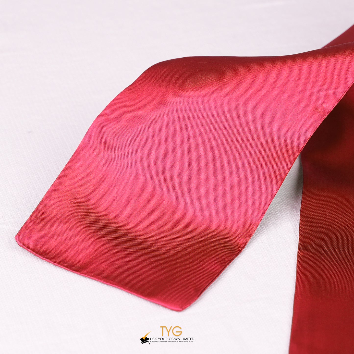 Detailed view of a red stole fabric on a white background.
